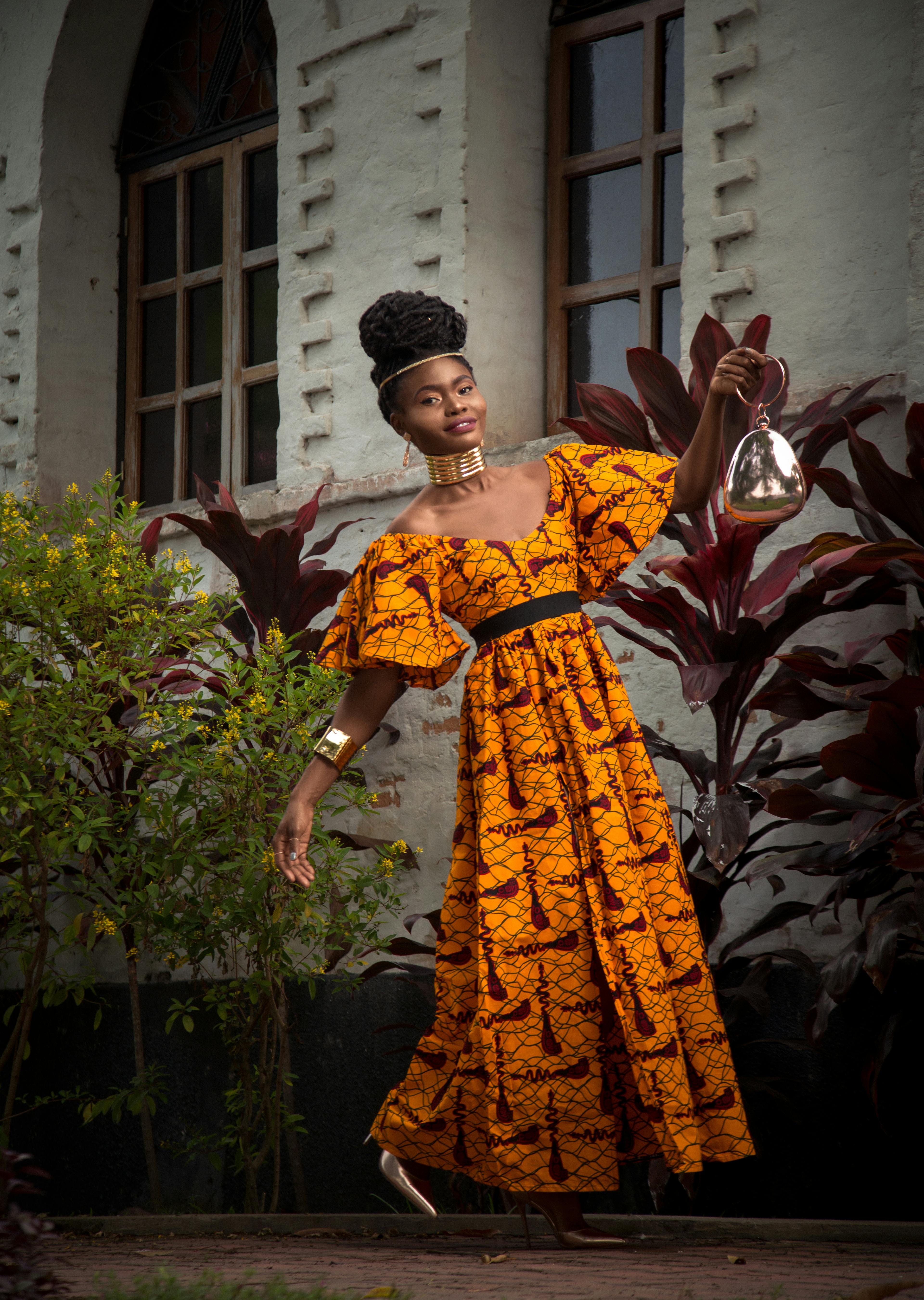 Rwandan creative in traditional print dress